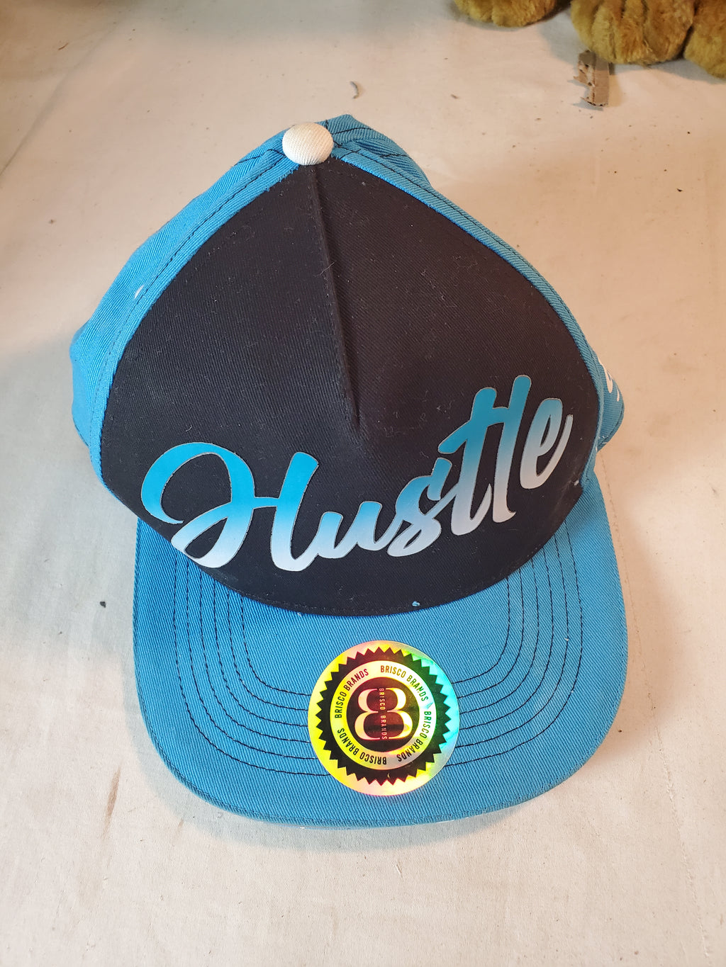 Brisco Brands Blue Snapback HUSTLE Cap with Money Bag Graphics